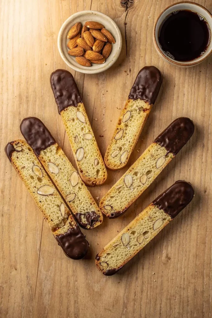 Overhead board of almond flour biscotti, half dipped in chocolate